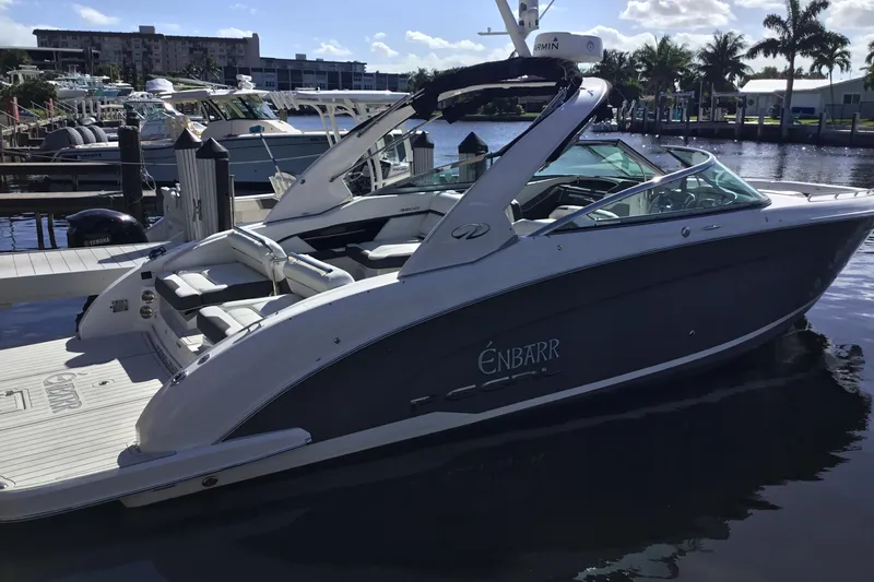 Enbarr Yacht Photos Pics 2017 Regal 3200 Bowrider boat docked at marina, sunny day, palm trees in background.