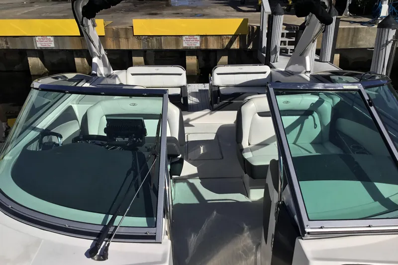Enbarr Yacht Photos Pics 2017 Regal 3200 Bowrider boat interior with seating and windshield at dock.