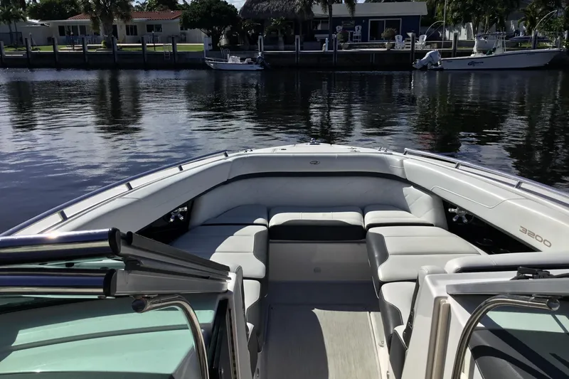 Enbarr Yacht Photos Pics 2017 Regal 3200 Bowrider boat with spacious seating on calm water.