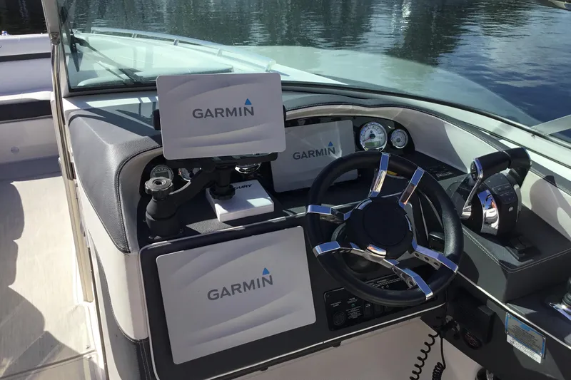Enbarr Yacht Photos Pics 2017 Regal 3200 Bowrider dashboard with Garmin navigation system and sleek steering wheel.