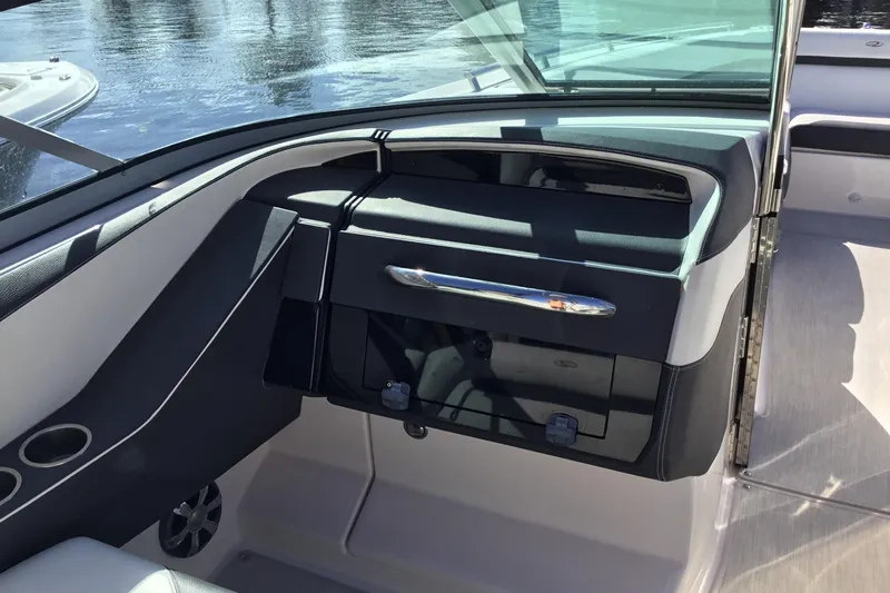 Enbarr Yacht Photos Pics 2017 Regal 3200 Bowrider interior dashboard with sleek design and storage compartment.