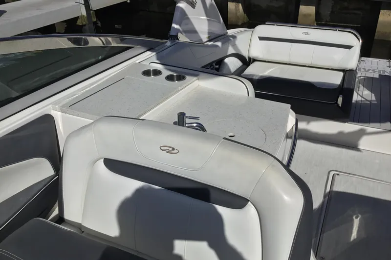 Enbarr Yacht Photos Pics 2017 Regal 3200 Bowrider interior with white seating and built-in cup holders.