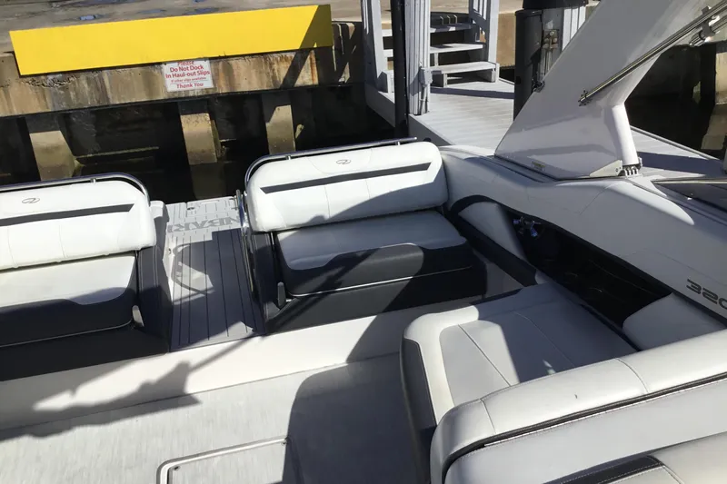 Enbarr Yacht Photos Pics 2017 Regal 3200 Bowrider interior with white seating, docked at a marina.