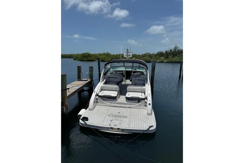 Enbarr Yacht Photos Pics 2017 Regal 3200 Bowrider docked on calm water under a clear sky.