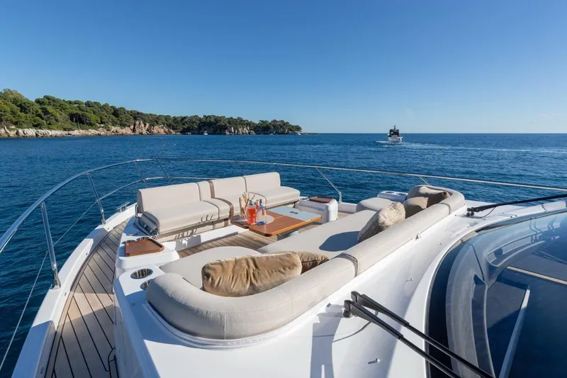  Yacht Photos Pics Luxurious 2025 Azimut Fly 62 yacht with elegant deck seating, cruising on serene blue waters.