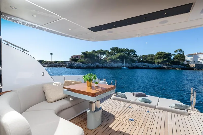  Yacht Photos Pics Luxurious 2025 Azimut Fly 62 yacht deck with elegant seating and scenic ocean view.