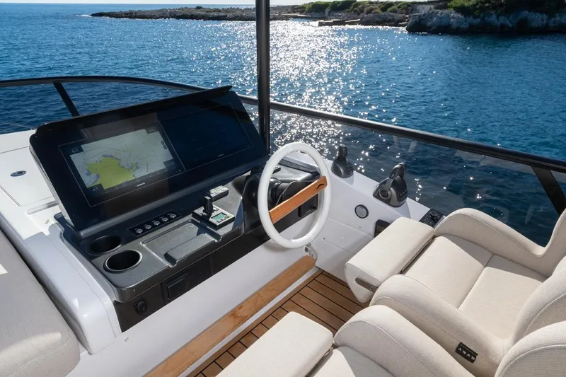  Yacht Photos Pics Helm of 2025 Azimut Fly 62 yacht with navigation display, overlooking ocean.