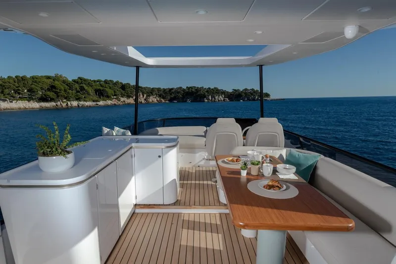  Yacht Photos Pics Luxurious Azimut Fly 62 yacht interior, 2025 model, featuring elegant dining setup and ocean view.