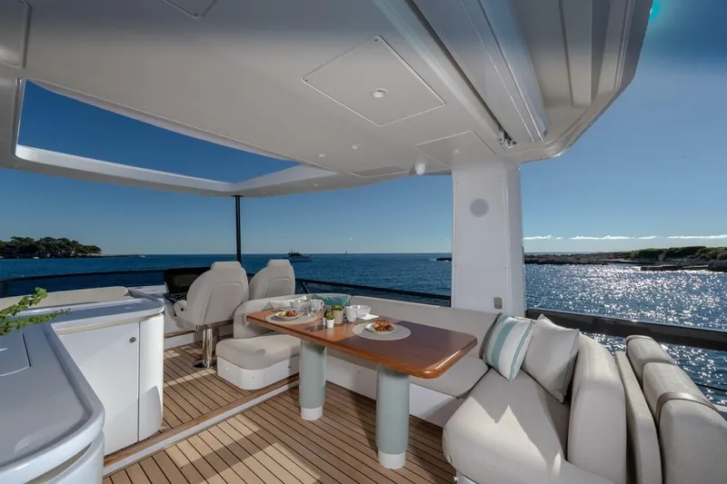  Yacht Photos Pics Luxurious 2025 Azimut Fly 62 yacht deck with ocean view and elegant seating area.