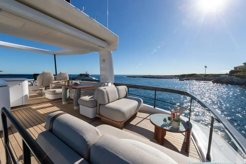  Yacht Photos Pics Luxurious 2025 Azimut Fly 62 yacht deck with ocean view and elegant seating.
