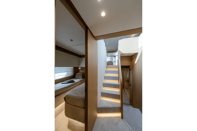  Yacht Photos Pics Luxurious interior of 2025 Azimut Fly 62 yacht with modern staircase and cozy cabin.