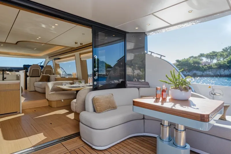  Yacht Photos Pics Luxurious 2025 Azimut Fly 62 yacht interior with elegant seating and ocean view.