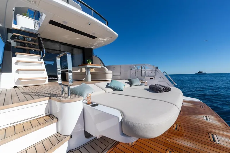  Yacht Photos Pics Luxurious 2025 Azimut Fly 62 yacht deck with sun loungers and ocean view.