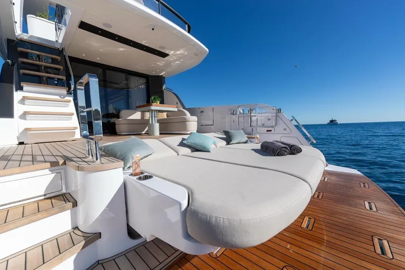  Yacht Photos Pics Luxurious 2025 Azimut Fly 62 yacht deck with sun loungers and ocean view.