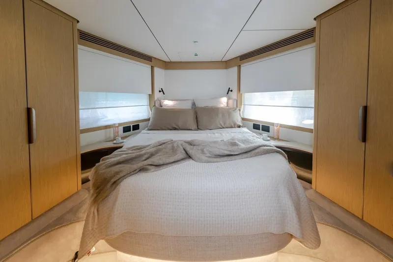  Yacht Photos Pics Luxurious bedroom interior of 2025 Azimut Fly 62 yacht with modern design and cozy bedding.