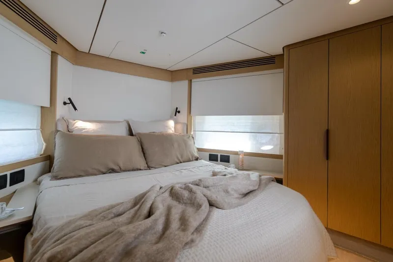  Yacht Photos Pics Luxurious bedroom interior of 2025 Azimut Fly 62 yacht with cozy bedding and modern design.