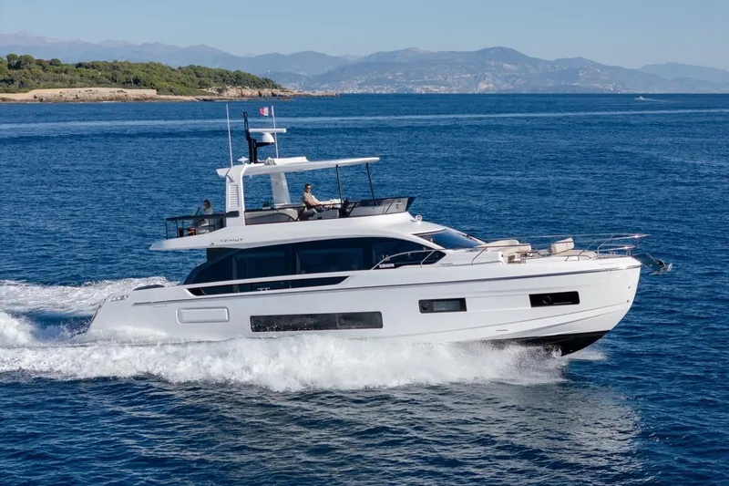  Yacht Photos Pics 2025 Azimut Fly 62 yacht cruising on open sea with scenic coastline backdrop.