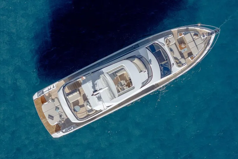  Yacht Photos Pics Aerial view of 2025 Azimut Fly 62 yacht on clear blue water.