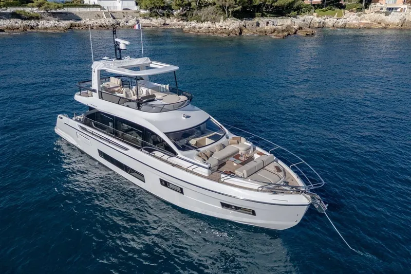  Yacht Photos Pics Luxurious 2025 Azimut Fly 62 yacht cruising in clear blue waters.