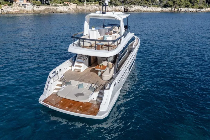  Yacht Photos Pics 2025 Azimut Fly 62 yacht cruising on clear blue waters, showcasing luxury design.