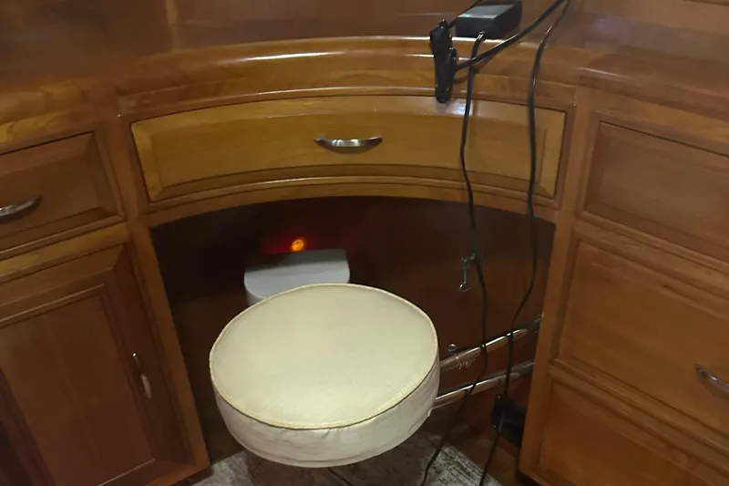  Yacht Photos Pics 1988 Ocean Alexander 42 aft cabin interior with wooden cabinetry and cushioned stool.