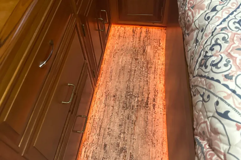  Yacht Photos Pics Ocean Alexander 42 aft cabin interior with wood cabinetry and illuminated flooring, 1988 model.