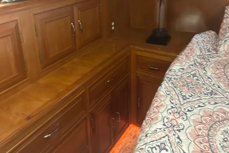  Yacht Photos Pics 1988 Ocean Alexander 42 aft cabin interior with wood cabinetry and patterned bedding.