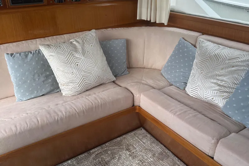  Yacht Photos Pics Cozy seating area with patterned cushions on 1988 Ocean Alexander 42 aft cabin yacht.