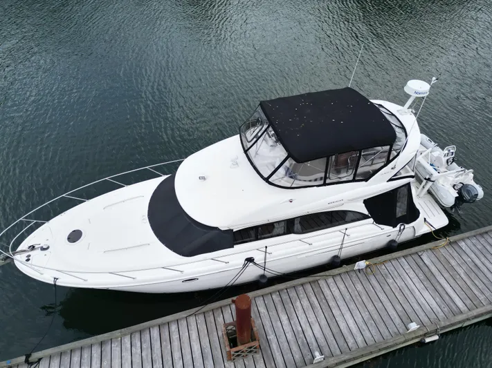Diamonds Wild Yacht Photos Pics 2006 Meridian 411 Sedan yacht docked at a marina, aerial view.