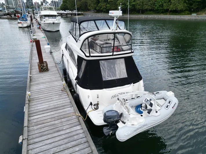 Diamonds Wild Yacht Photos Pics 2006 Meridian 411 Sedan yacht docked with inflatable boat, marina background.