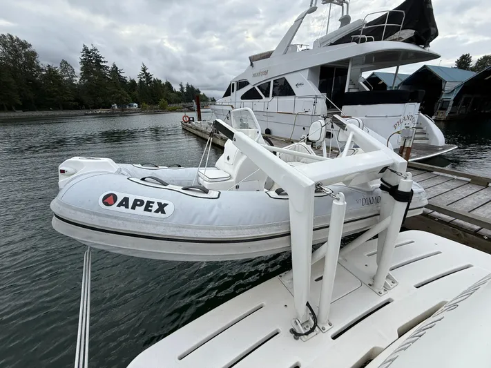 Diamonds Wild Yacht Photos Pics Inflatable Apex boat on 2006 Meridian 411 Sedan yacht, docked by a scenic waterfront.