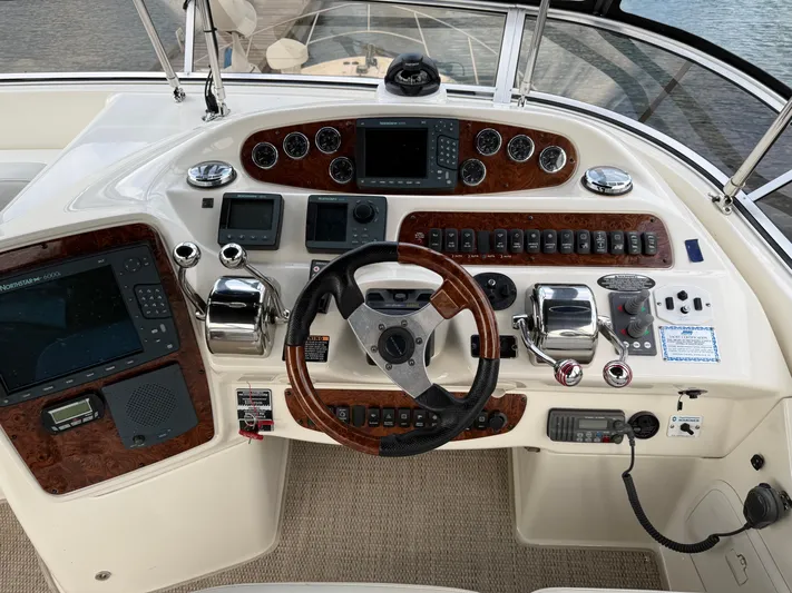 Diamonds Wild Yacht Photos Pics Helm of 2006 Meridian 411 Sedan with navigation controls and wood accents.