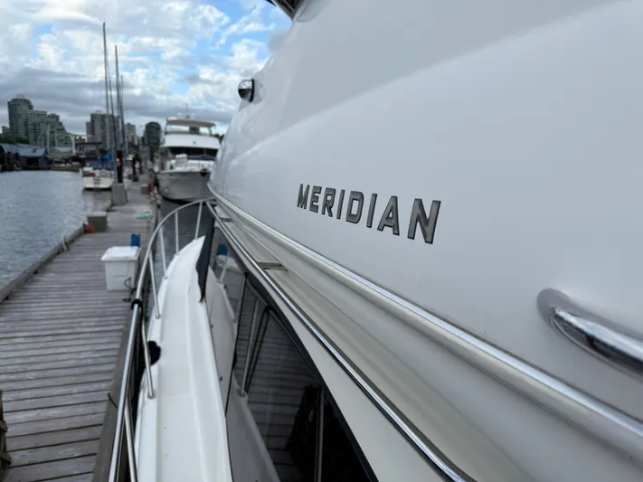 Diamonds Wild Yacht Photos Pics 2006 Meridian 411 Sedan yacht docked at marina with city skyline background.