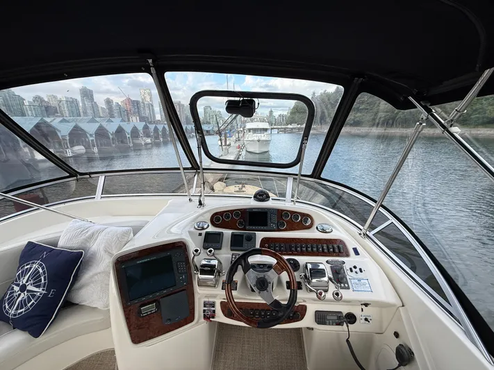 Diamonds Wild Yacht Photos Pics Helm of 2006 Meridian 411 Sedan yacht with cityscape and marina view.