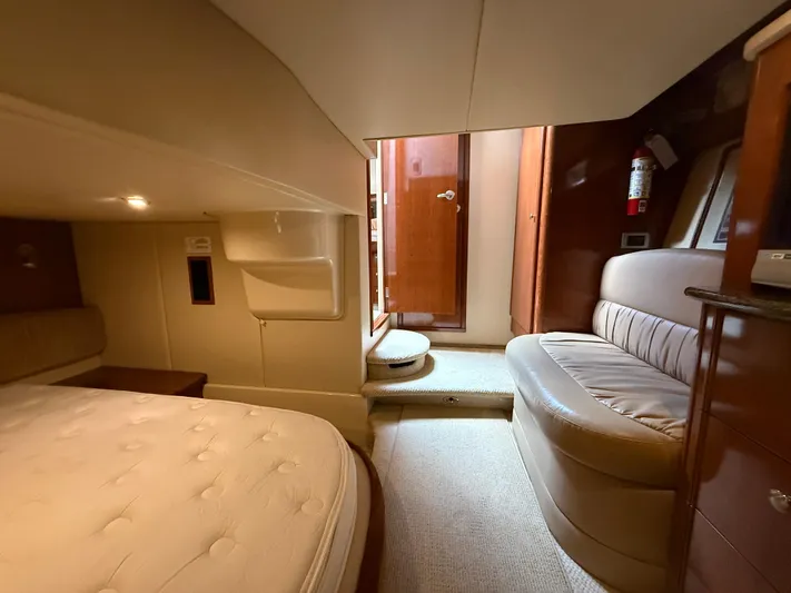 Diamonds Wild Yacht Photos Pics Interior of 2006 Meridian 411 Sedan yacht with bed, seating, and wooden door.