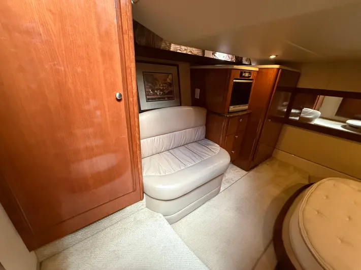 Diamonds Wild Yacht Photos Pics Luxurious interior of 2006 Meridian 411 Sedan yacht with wood cabinetry and plush seating.