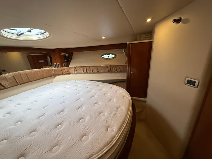 Diamonds Wild Yacht Photos Pics Luxurious cabin interior of 2006 Meridian 411 Sedan yacht with plush bedding and elegant wood finishes.