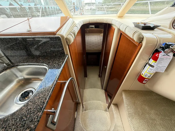Diamonds Wild Yacht Photos Pics Interior view of 2006 Meridian 411 Sedan yacht with kitchen sink and cabin entrance.