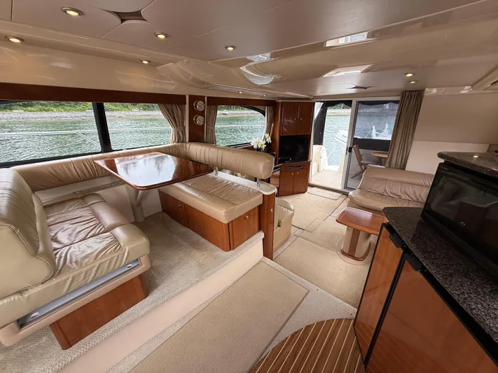 Diamonds Wild Yacht Photos Pics Luxurious interior of a 2006 Meridian 411 Sedan yacht with elegant seating and dining area.