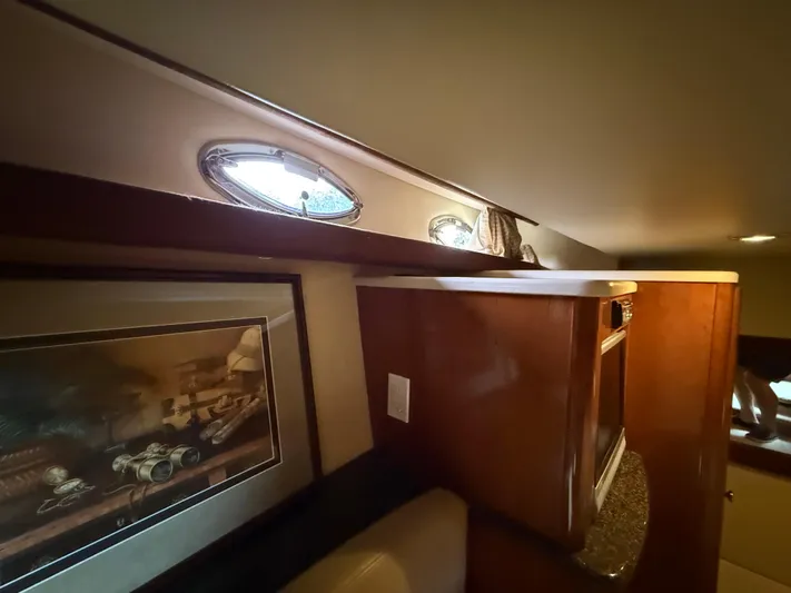 Diamonds Wild Yacht Photos Pics Interior of 2006 Meridian 411 Sedan yacht with wood cabinetry and framed artwork.