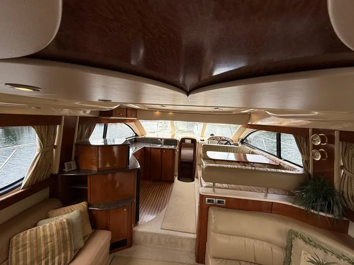 Diamonds Wild Yacht Photos Pics Luxurious interior of a 2006 Meridian 411 Sedan yacht with elegant wood finishes.