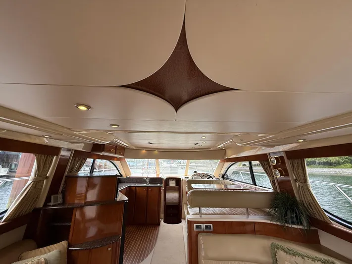 Diamonds Wild Yacht Photos Pics Luxurious interior of a 2006 Meridian 411 Sedan yacht with elegant wood finishes.
