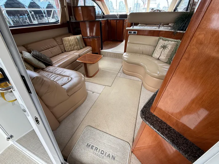 Diamonds Wild Yacht Photos Pics Luxurious interior of a 2006 Meridian 411 Sedan yacht with leather seating and wooden accents.