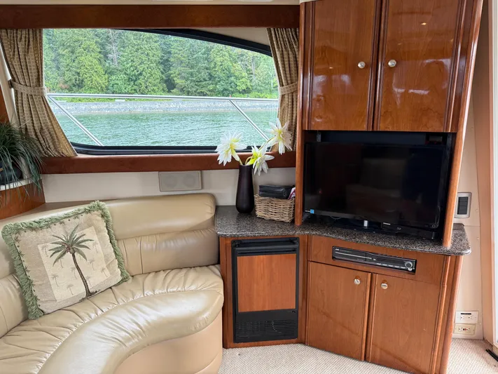 Diamonds Wild Yacht Photos Pics Interior of 2006 Meridian 411 Sedan yacht with leather seating, TV, and scenic window view.