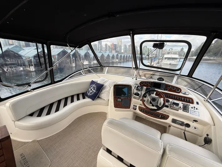 Diamonds Wild Yacht Photos Pics Interior of 2006 Meridian 411 Sedan yacht with helm and seating area.