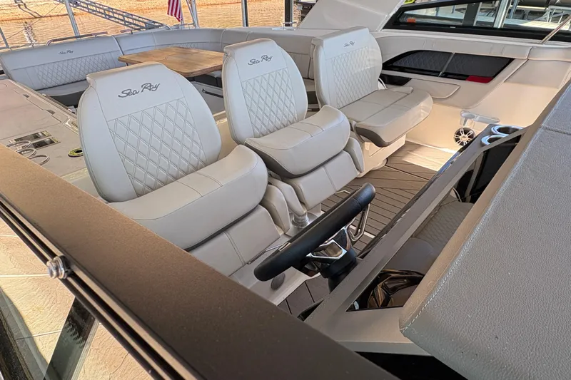  Yacht Photos Pics 2023 Sea Ray SLX 400 boat interior with luxurious seating and steering wheel.
