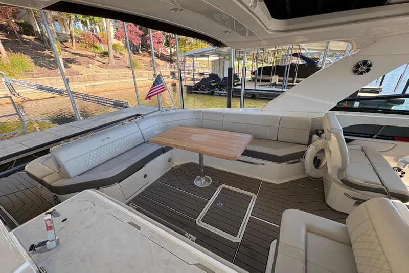  Yacht Photos Pics 2023 Sea Ray SLX 400 boat interior with elegant seating and wooden table.