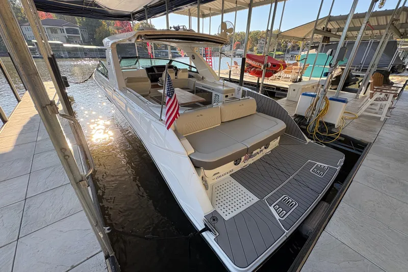  Yacht Photos Pics 2023 Sea Ray SLX 400 boat docked, featuring spacious seating and American flag.