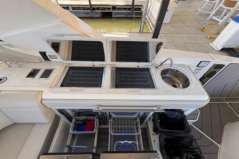  Yacht Photos Pics 2023 Sea Ray SLX 400 boat kitchen with grill and sink setup.