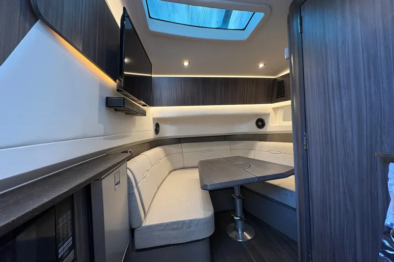  Yacht Photos Pics Luxurious interior of 2023 Sea Ray SLX 400 yacht with modern seating and skylight.